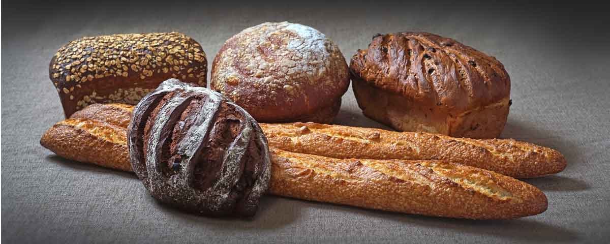 Assorted artisan breads and baguettes from La Baguette French Bakery